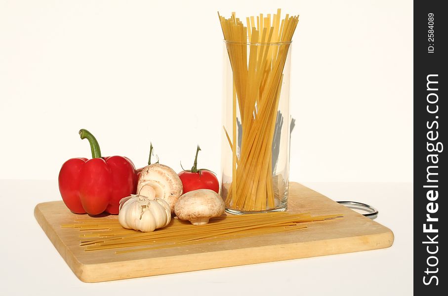 Fetuccini and ingredients on a cutting board. Fetuccini and ingredients on a cutting board