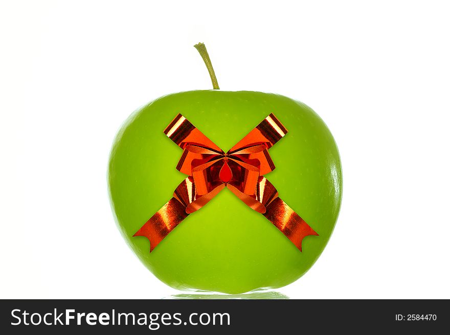 Green apple with a red ribbon. Isolated over white background