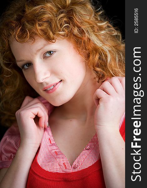 Portrait of a young red-haired woman looking sweetly into the camera. Portrait of a young red-haired woman looking sweetly into the camera