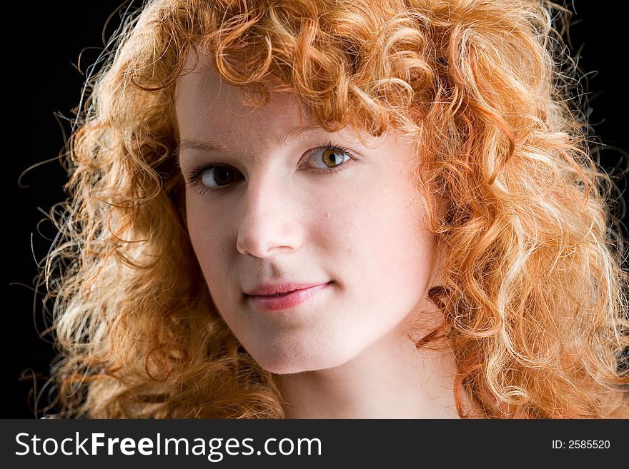Portrait of a young red-haired woman looking into the camera. Portrait of a young red-haired woman looking into the camera
