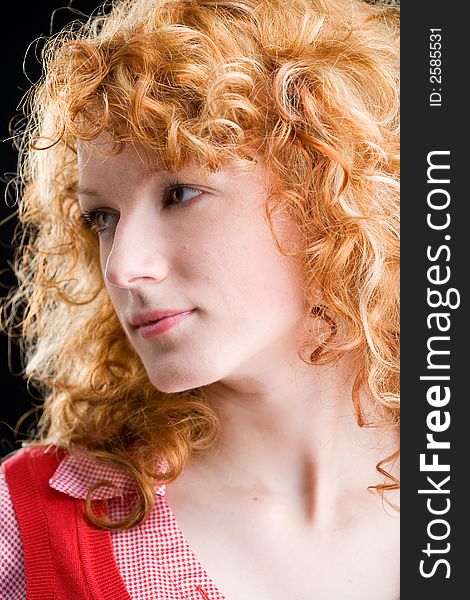 Portrait of a young red-haired woman looking sideways