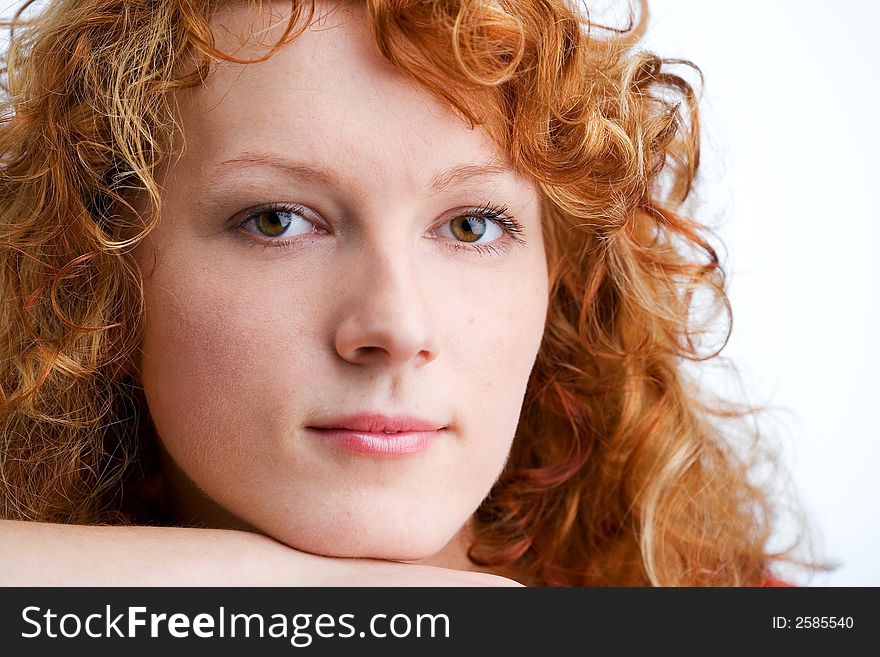 Close-up of a young red-haired woman looking into the camera. Close-up of a young red-haired woman looking into the camera