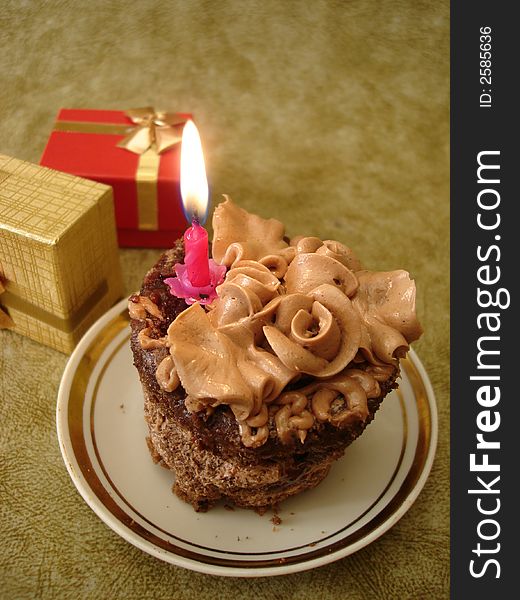 Birthday cake with candle and gifts