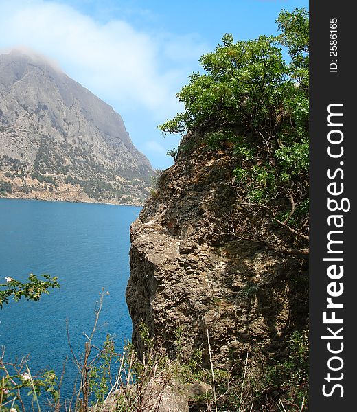 Beautiful landscape (big mountain, blue sea and sky with clouds)