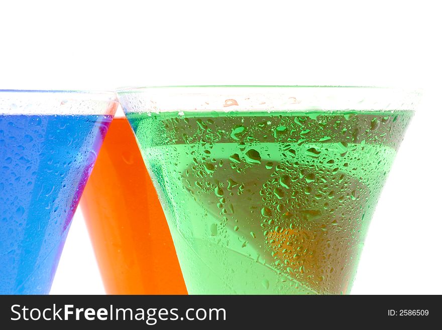 Red green and blue liquids in a glasses on a white background. Red green and blue liquids in a glasses on a white background