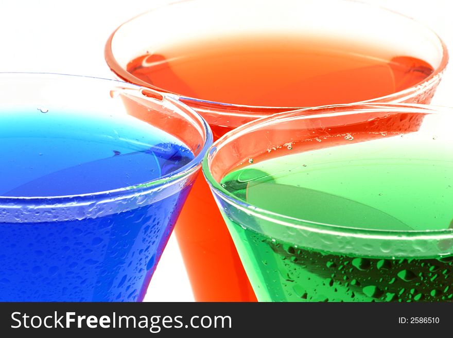 View at different colour liquids in a glasses on a white background. View at different colour liquids in a glasses on a white background