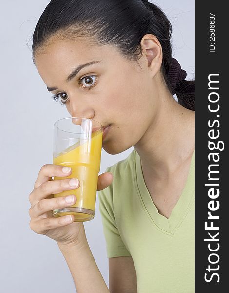 Girl holding glass with juice and drinking. Girl holding glass with juice and drinking