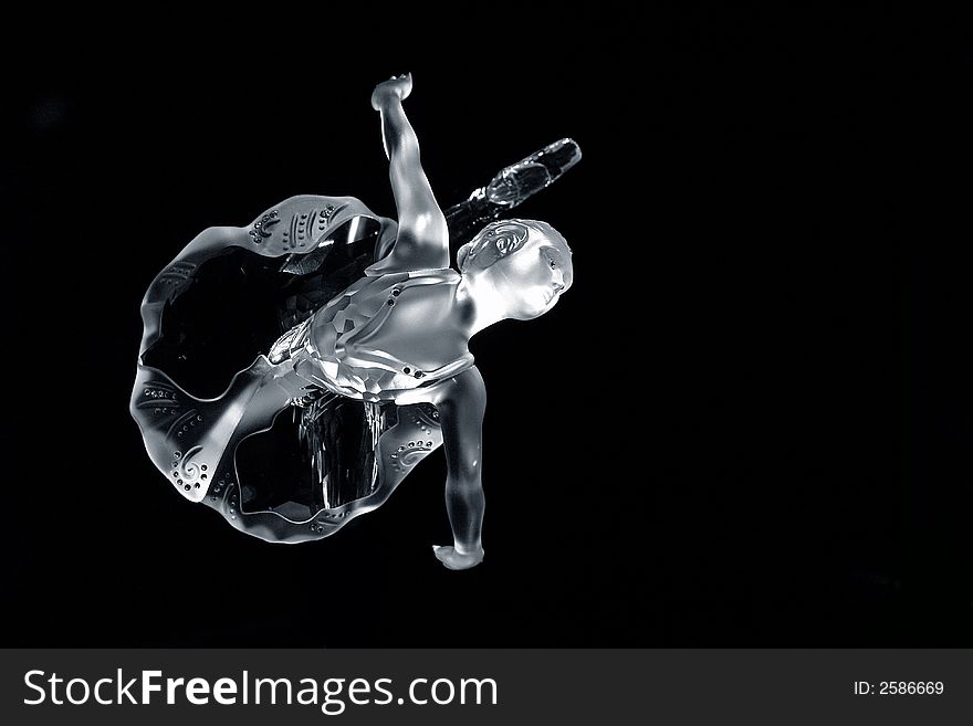 A crystal ballerina dancing on a black background