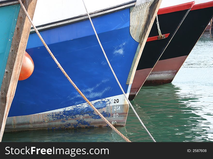 The bows of fishing boats which are moored in the harbour. The bows of fishing boats which are moored in the harbour