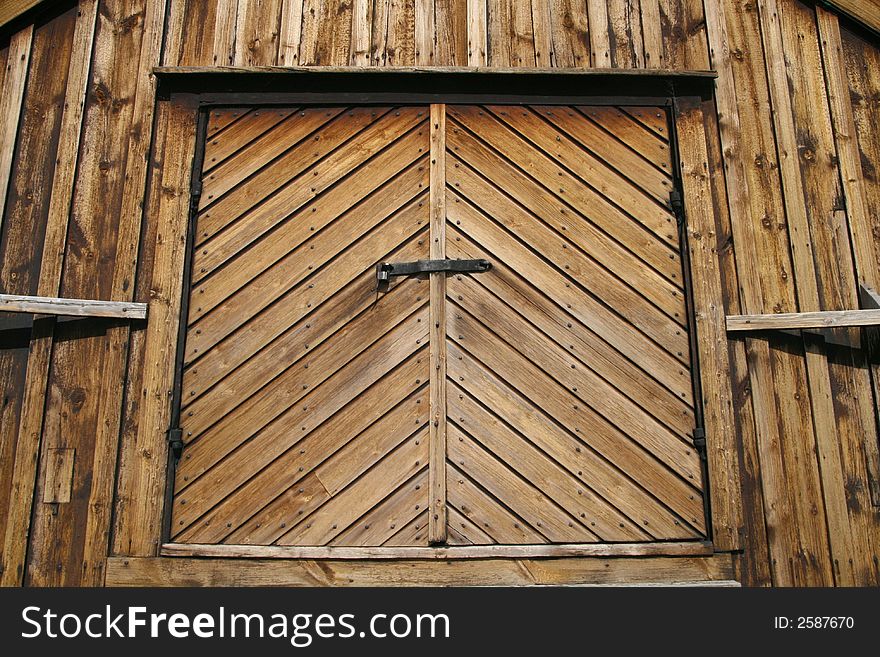 Ancient wooden gate with solid lock. Ancient wooden gate with solid lock