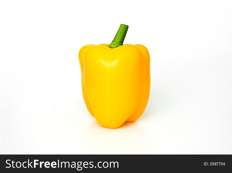 Yellow paprika with green cutting on white background