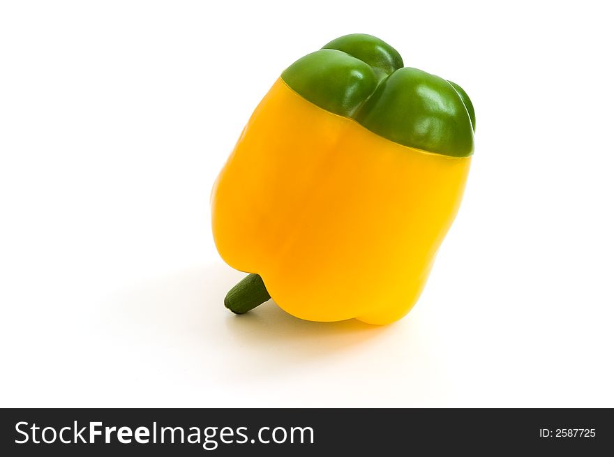 Yellow paprika with the green hat on white background. Yellow paprika with the green hat on white background
