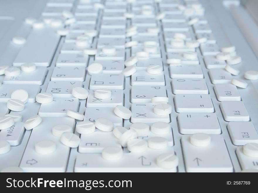 Tablets on the white notebook keyboard. Tablets on the white notebook keyboard