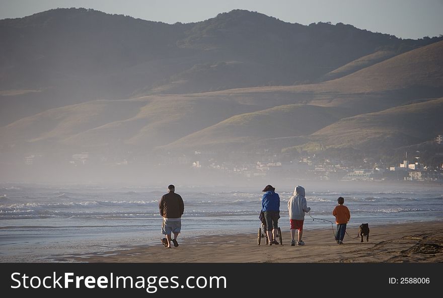 Family walking on ocean beach. Family walking on ocean beach.