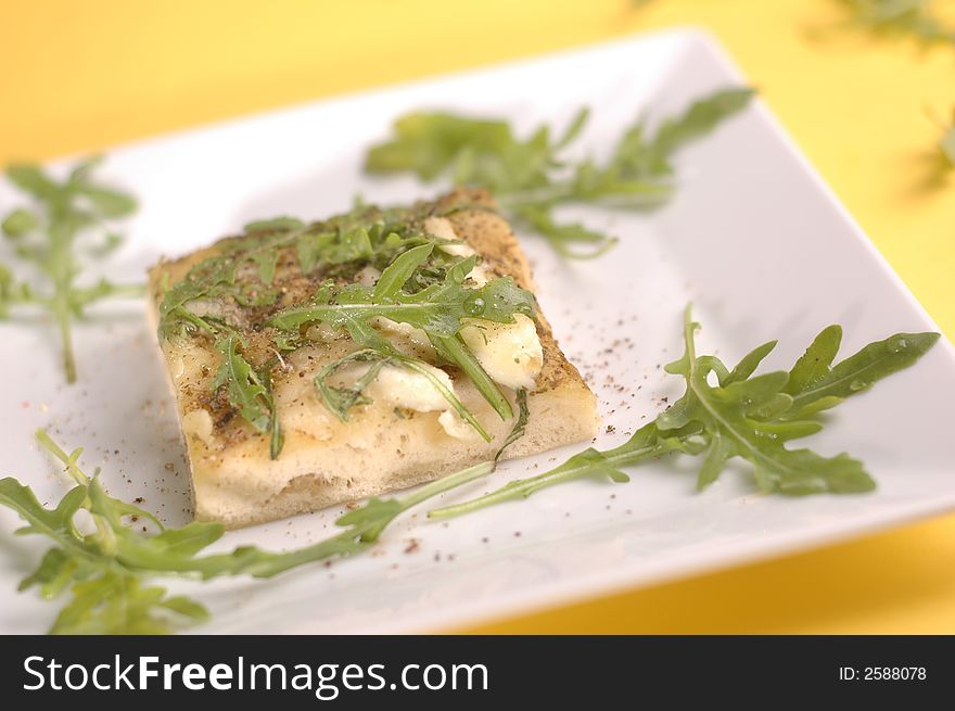 proud pizza with herbs and cheese on the yellow background