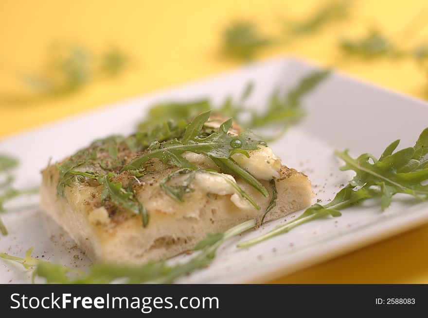 proud pizza with herbs and cheese on the yellow background