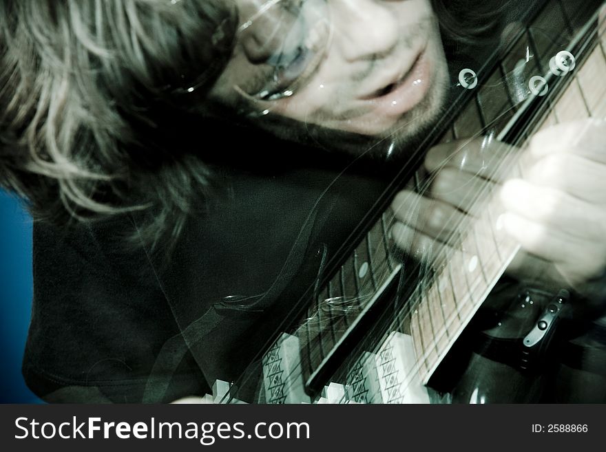 Rocker playing electric guitar, zoom and strobe lighting. Rocker playing electric guitar, zoom and strobe lighting.