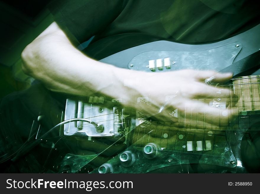 Hand in motion on electric guitar, strobe lighting. Hand in motion on electric guitar, strobe lighting