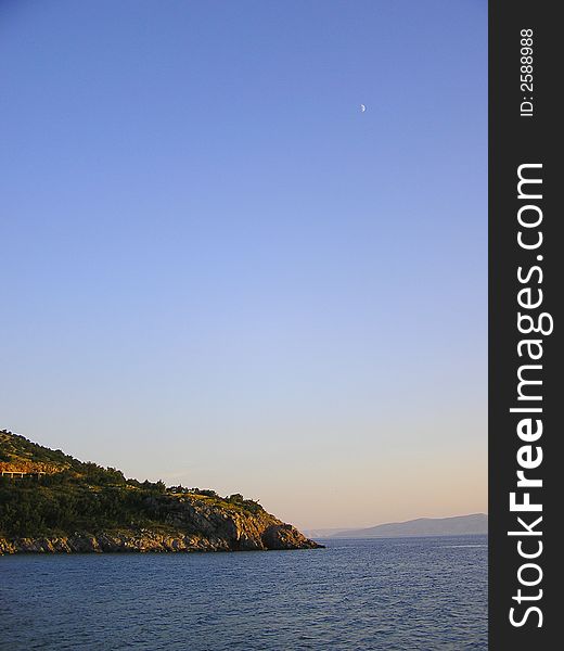 Croatian seaside with Moon before sunset