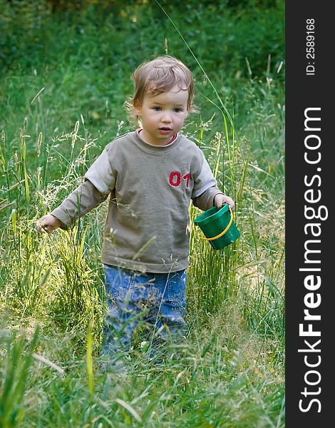 Lovely child plays to a grass