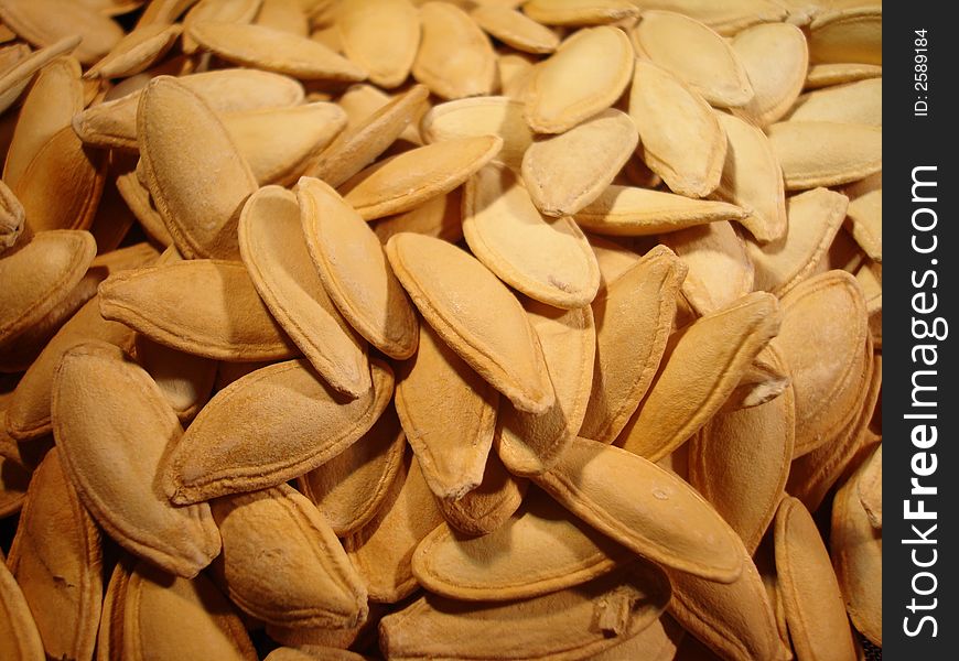 Close up of un-roasted pumpkin seeds.