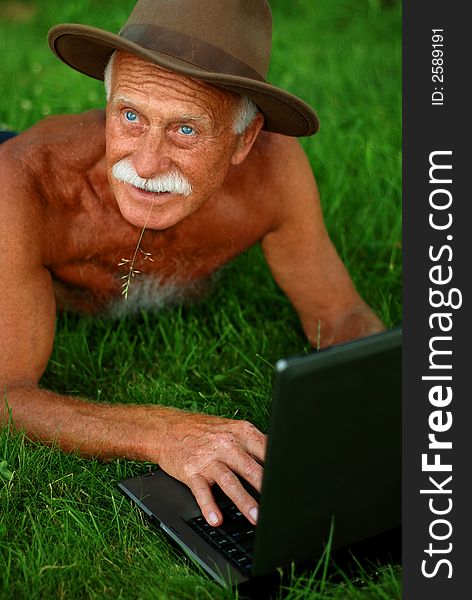 Handsome senior man with computer