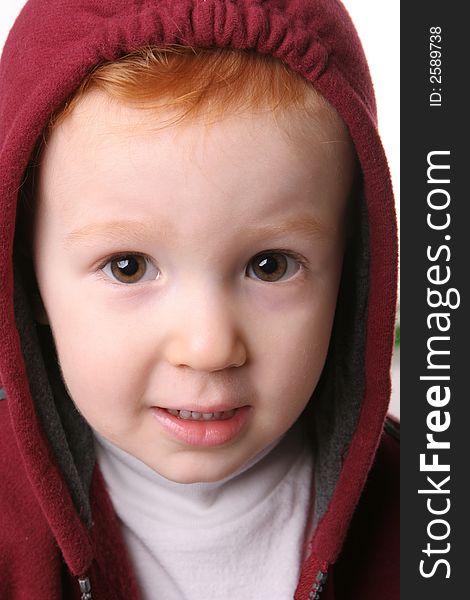 Closeup of redhead in maroon hood. Closeup of redhead in maroon hood