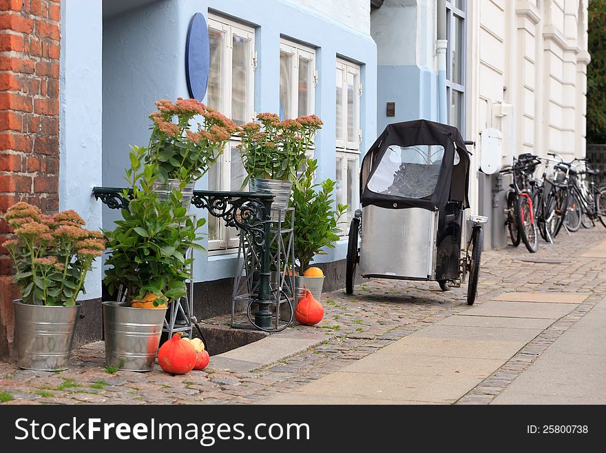 Tricycle parked outside a blue house in Copenhagen Denmark. Tricycle parked outside a blue house in Copenhagen Denmark