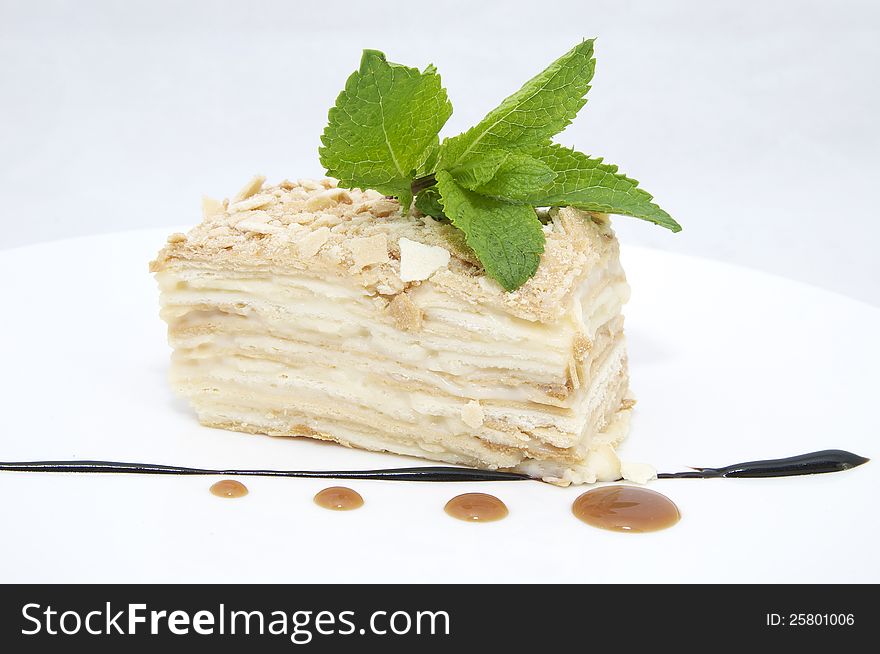 Layered dessert on a white background decorate with mint. Layered dessert on a white background decorate with mint