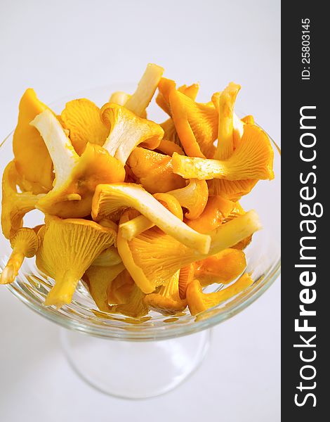 Clean chanterelle mushrooms in a glass bowl ready to be cooked. Clean chanterelle mushrooms in a glass bowl ready to be cooked