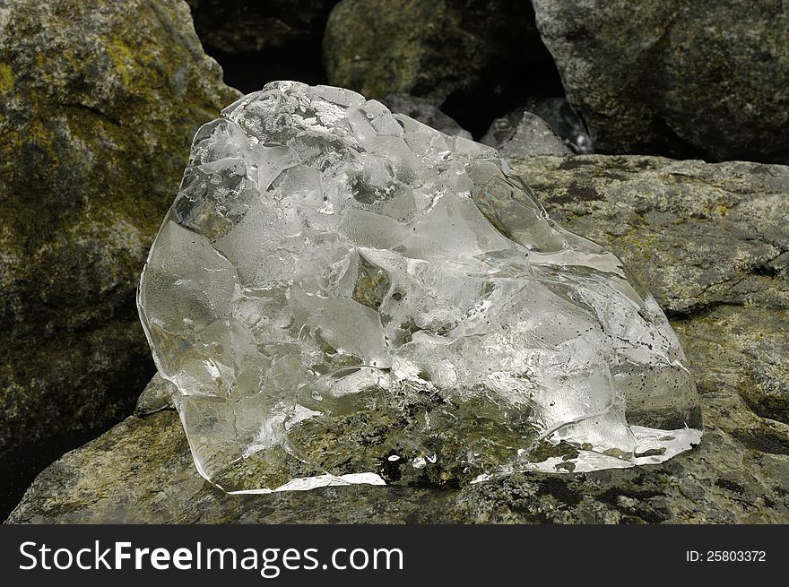 Crystal transparency of ice block on the rock. Crystal transparency of ice block on the rock.