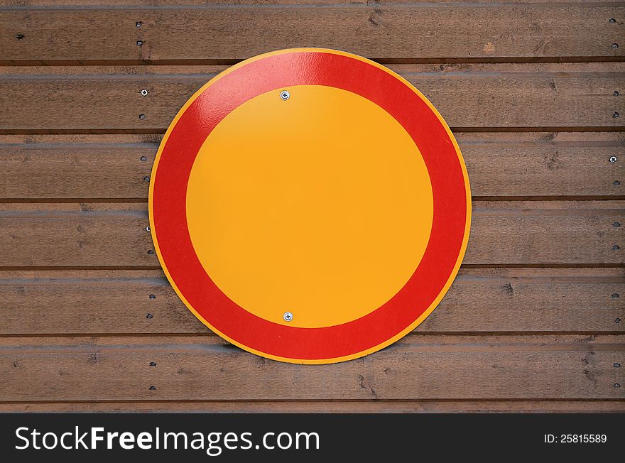 Blank yellow sign with red boarder on wooden wall. Blank yellow sign with red boarder on wooden wall.