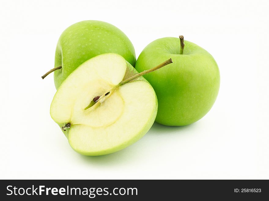Two green apples and one half on white background. Two green apples and one half on white background