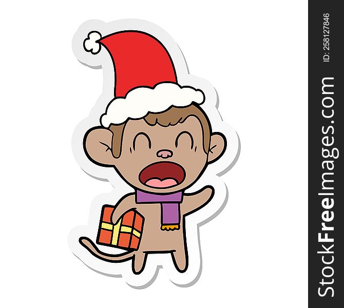 shouting hand drawn sticker cartoon of a monkey carrying christmas gift wearing santa hat