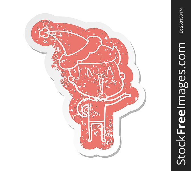 quirky cartoon distressed sticker of a excited man wearing santa hat