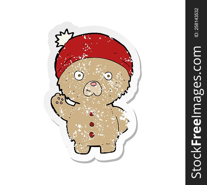 retro distressed sticker of a cartoon waving teddy bear in winter hat