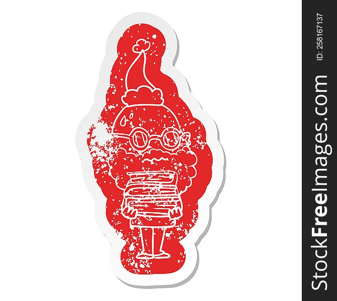 Cartoon Distressed Sticker Of A Worried Man With Beard And Stack Of Books Wearing Santa Hat