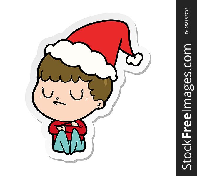 hand drawn sticker cartoon of a grumpy boy wearing santa hat