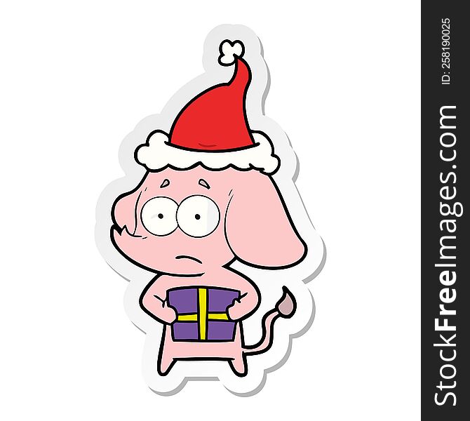 Sticker Cartoon Of A Unsure Elephant With Christmas Present Wearing Santa Hat