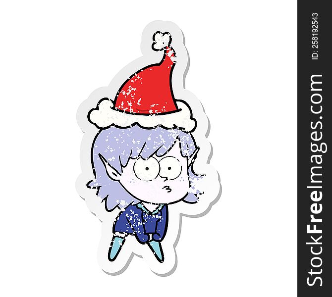 distressed sticker cartoon of a elf girl staring and crouching wearing santa hat