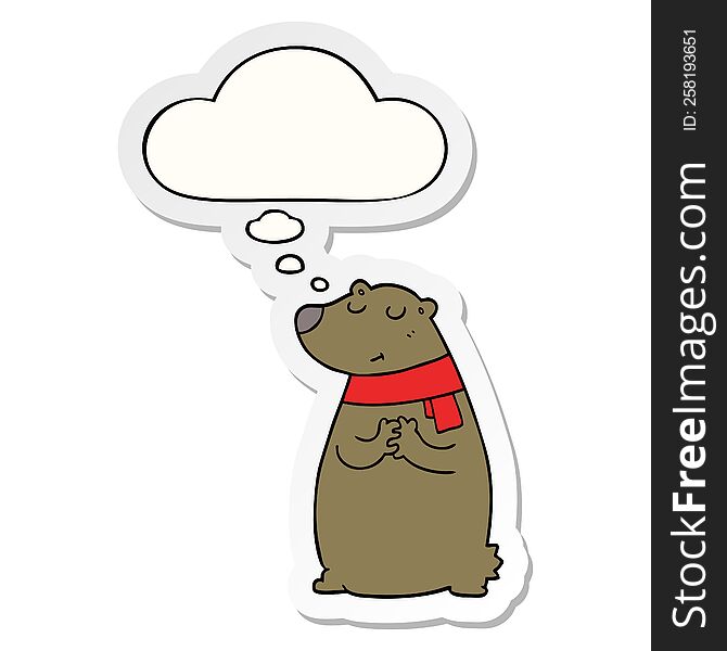 cartoon bear wearing scarf with thought bubble as a printed sticker