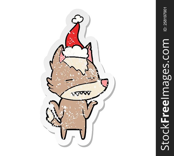 hand drawn distressed sticker cartoon of a wolf showing teeth wearing santa hat