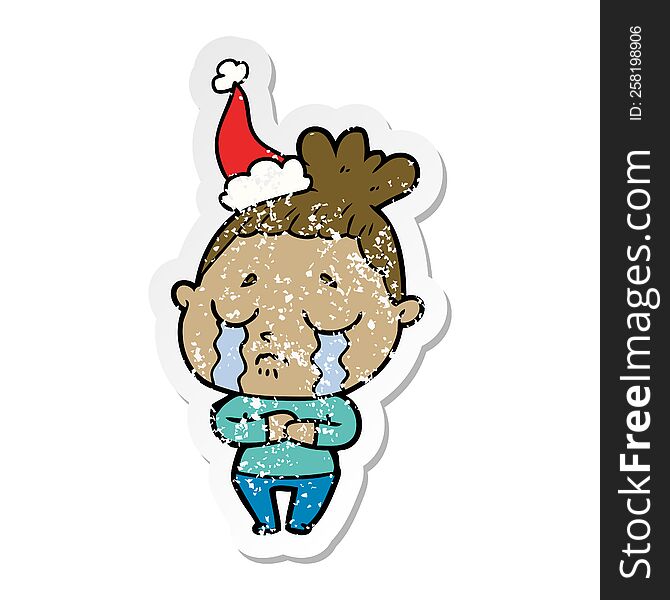 hand drawn distressed sticker cartoon of a crying woman wearing santa hat