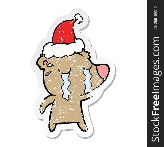 Distressed Sticker Cartoon Of A Crying Bear Wearing Santa Hat