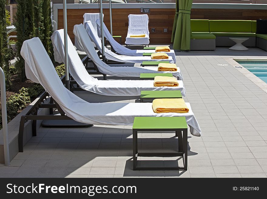 Poolside deck chairs prepared for sun bathers