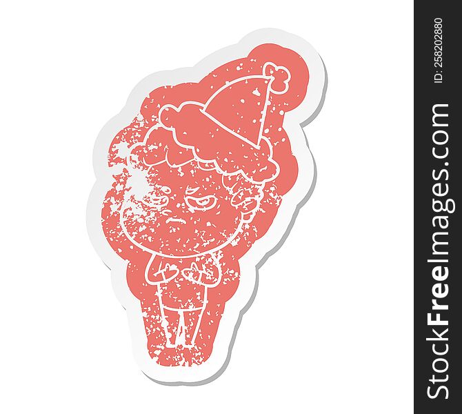 cartoon distressed sticker of a angry man wearing santa hat