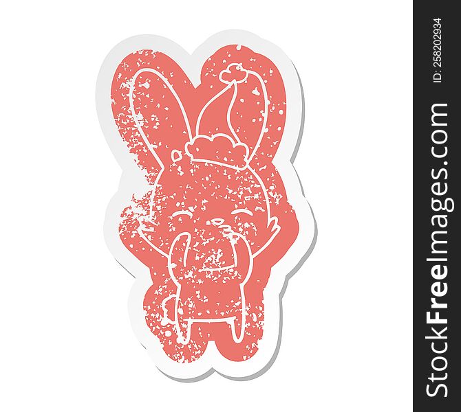 curious bunny quirky cartoon distressed sticker of a wearing santa hat