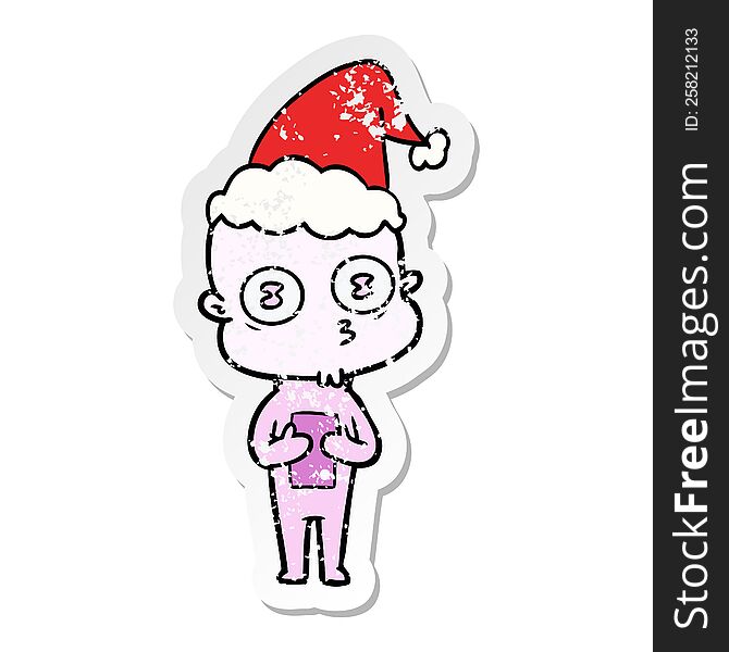 distressed sticker cartoon of a weird bald spaceman wearing santa hat