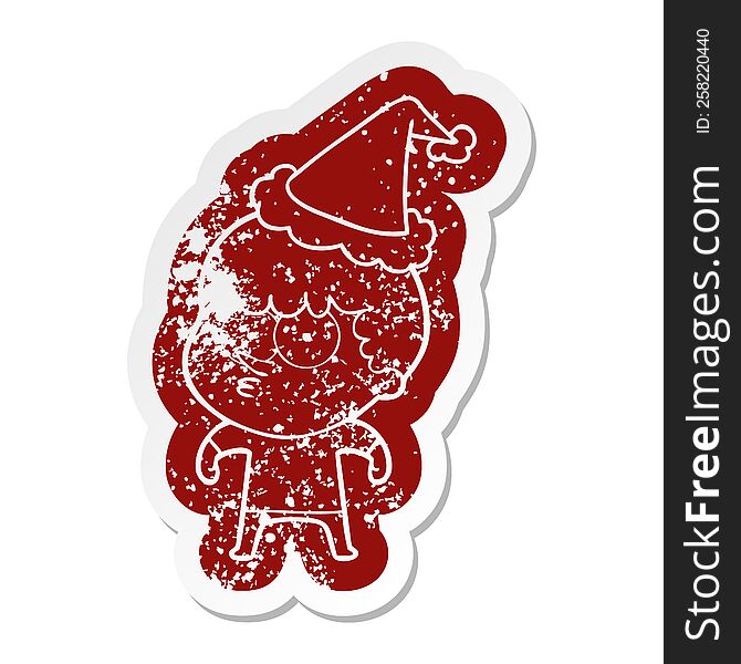 Cartoon Distressed Sticker Of A Curious Boy Wearing Santa Hat