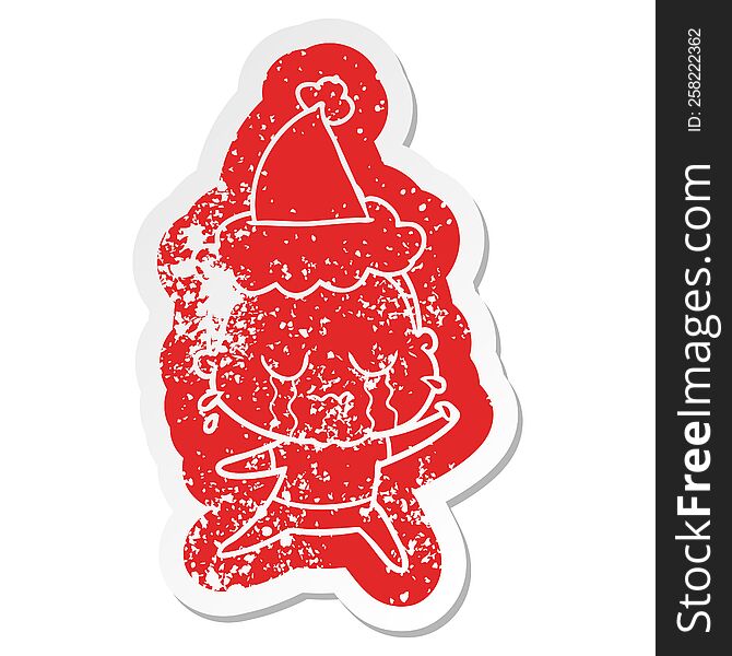 Cartoon Distressed Sticker Of A Crying Old Lady Wearing Santa Hat